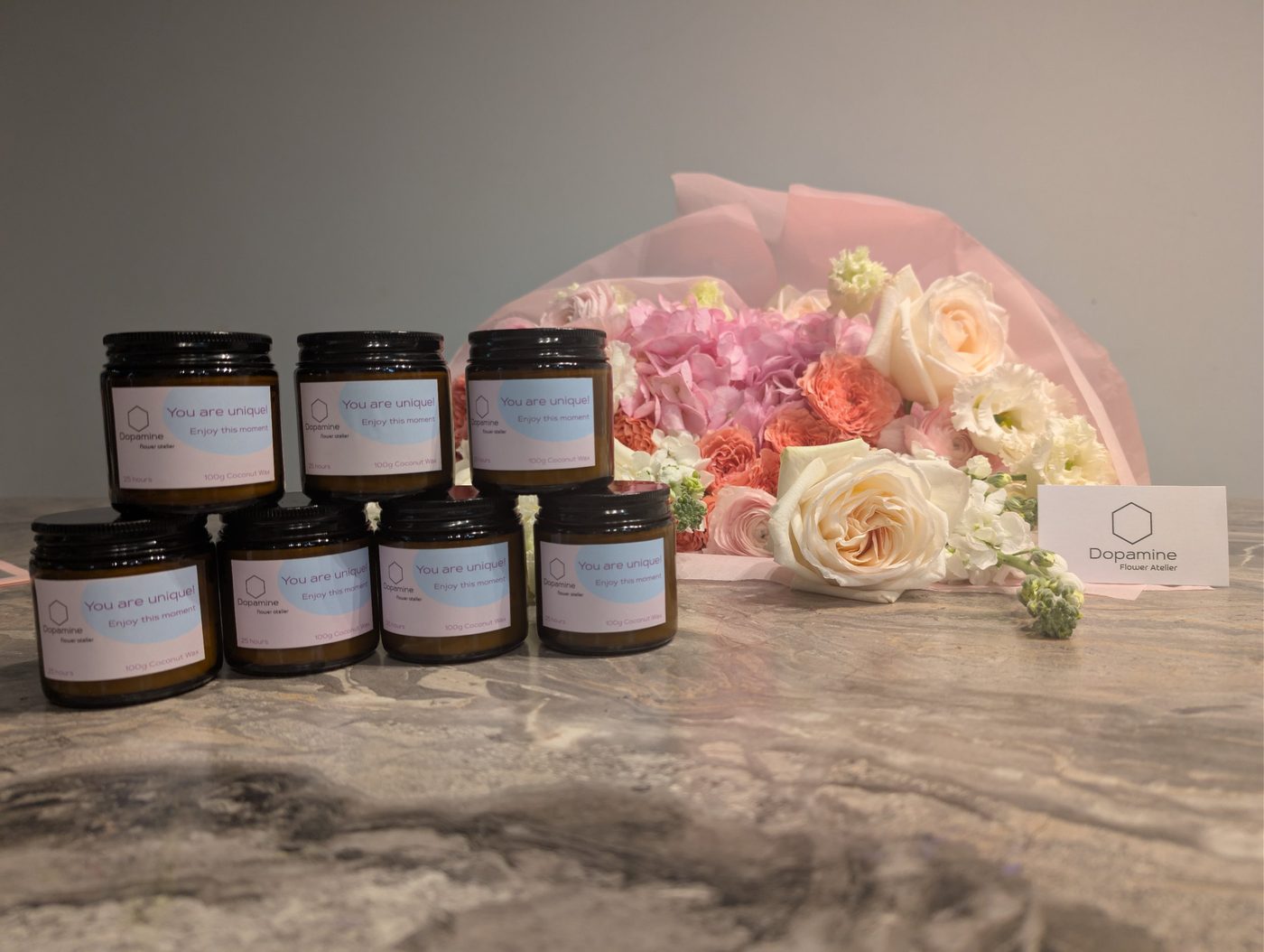Svíčky EchoArt s etiketou Dopamine flower atelier vedle kytice
